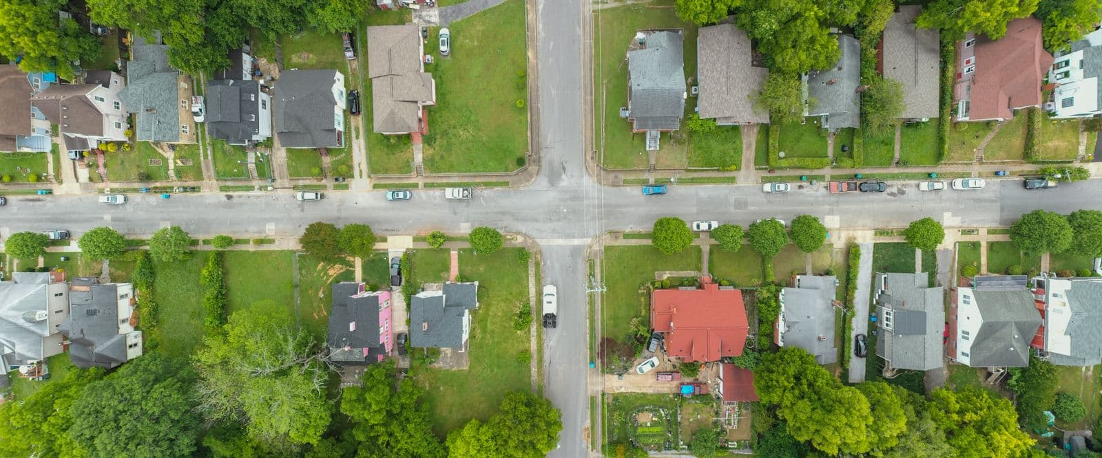 An aerial view of a leafy residential intersection